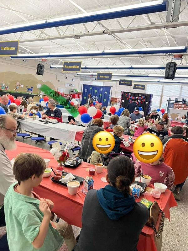 students and veterans sitting in lunch room have lunch