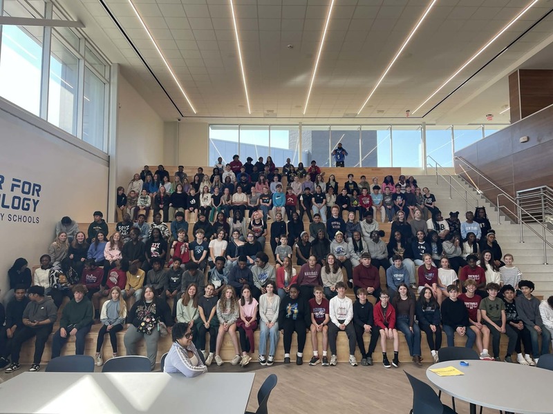 Middle School students from Huntsville Jr High sit on the stairs at HCT