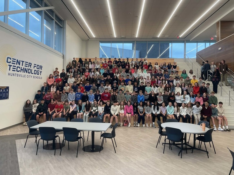 Students from Hampton Cove Middle School sit on the stairs at HCT