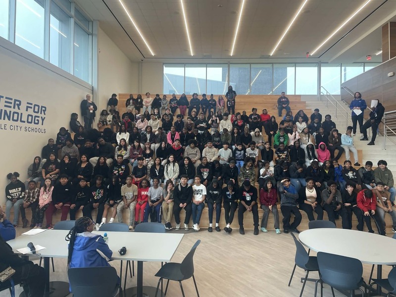 Students from Williams Middle School sit on the stairs at HCT