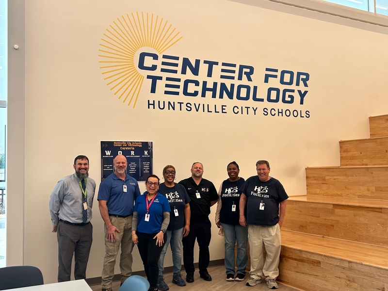 CTE staff pose with Ms. Robinson in front of the Center for Technology logo
