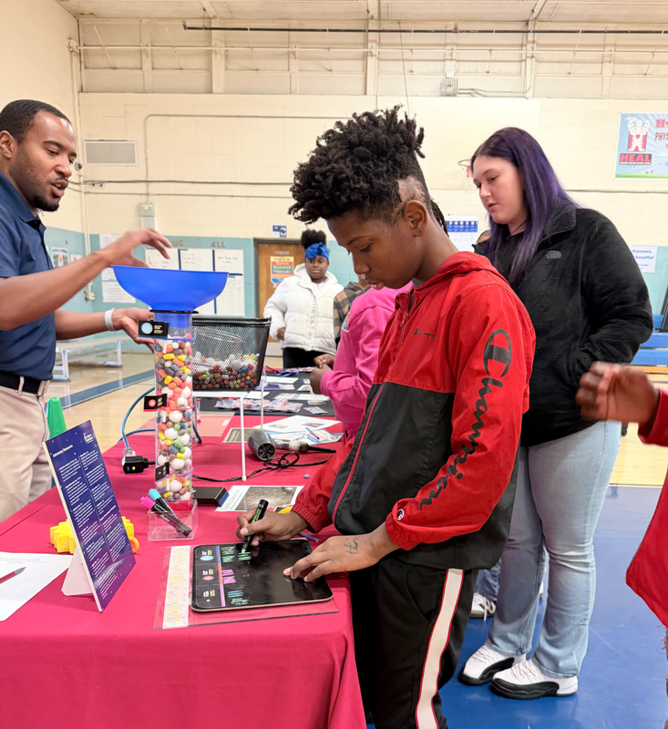 Students are gathered around the learning table after the presentation. Students created stars, and tracked the data.