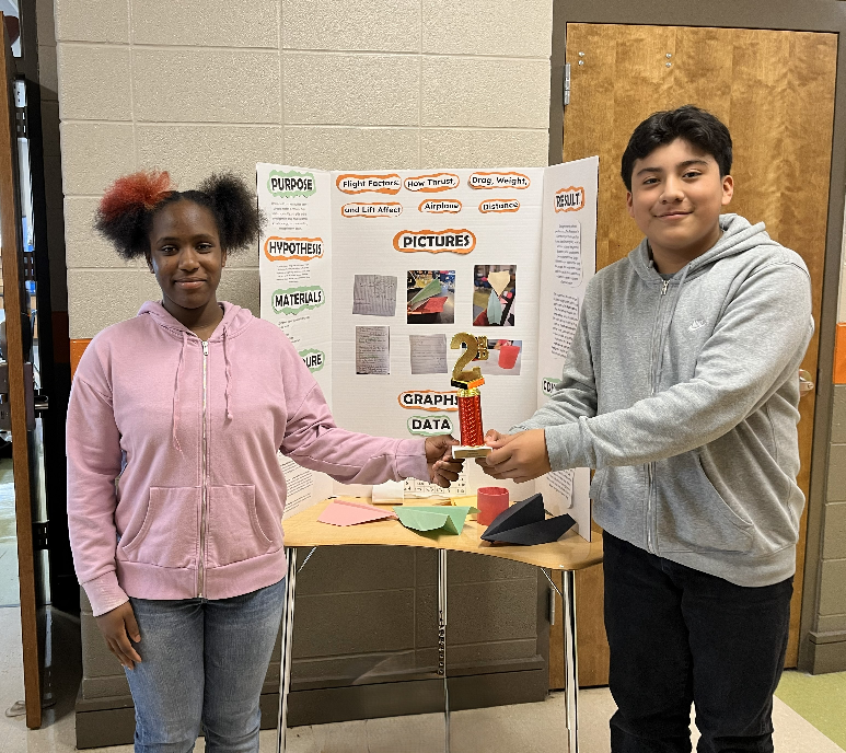 Moore and Nerei-Perez pose with their project and 2nd place  trophy