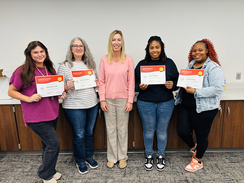 Blossomwood teachers and staff show their completion certificates