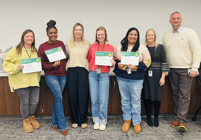 ASFL teachers and staff show their completion certificates