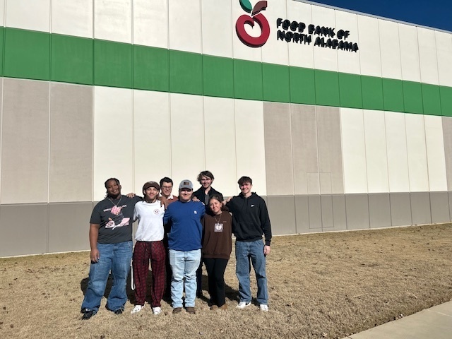 Students stand in front of the Food Bank of North Alabama