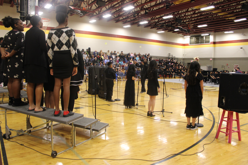 A view of the audience from behind the 6th grade choir