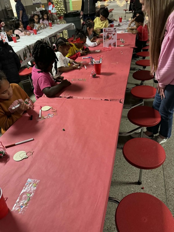 1st grade students hard at work coloring their wooden ornaments.