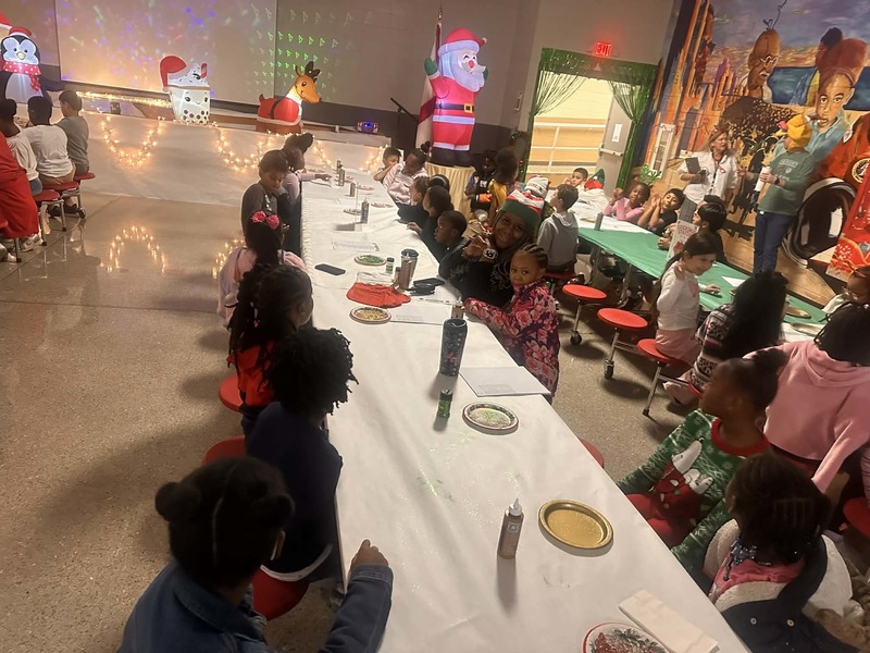2nd grade students with teacher, Mrs. Branch-Robinson, about to work on their stockings.