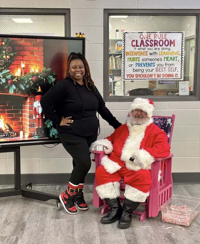 Ms. Toney, our fifth grade teacher, posing with Santa.