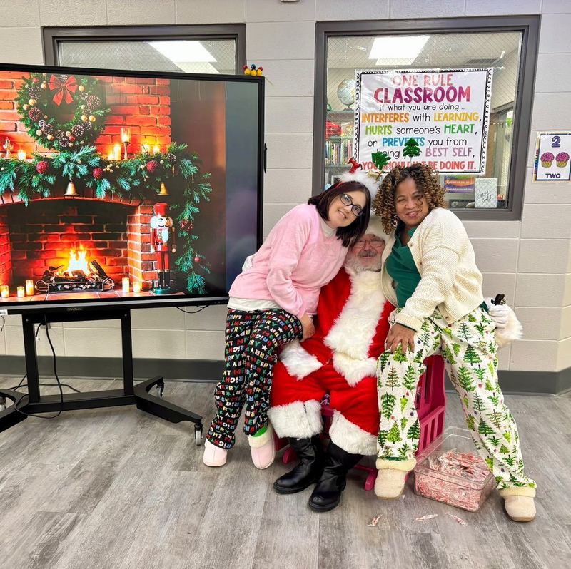 Ms. Johnson and Ms. Barksdale visiting with Santa. 