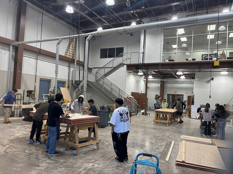 Students in a building sciences shop working on various pieces of carpentry
