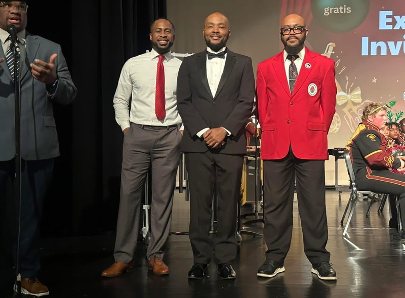 Theatre, Choir and Band teachers standing on stage with the principal of CHS on the left