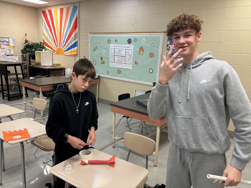 A duo completing their rocket activity in science class.