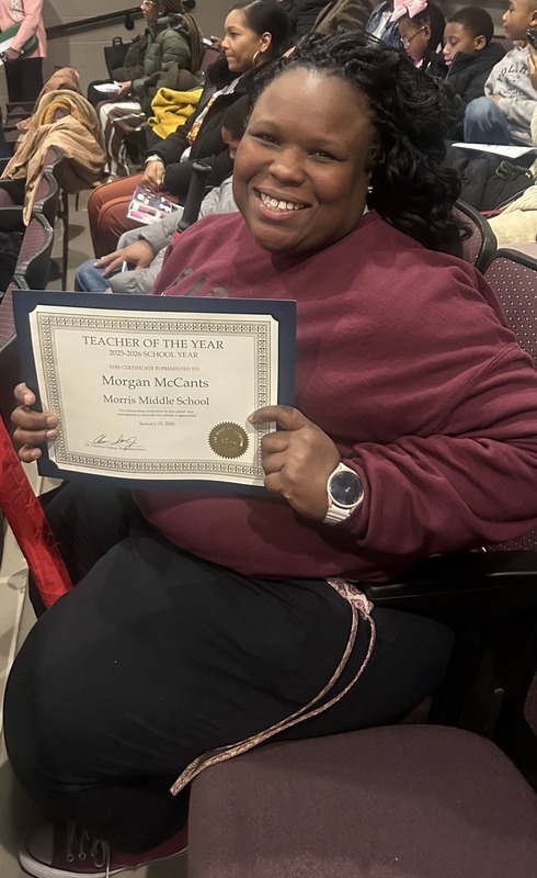 Ms. McCants poses with her certificate