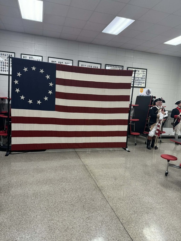 The American Flag representing the thirteen colonies.