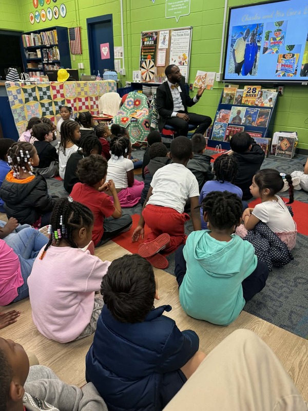 Mr. Saulsberry reading "Pearl and Her Gee's Bend Quilt" to kindergarten and first grade.