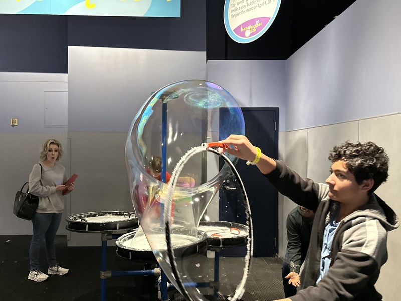 a cms student using bubble to learn about science at the science center