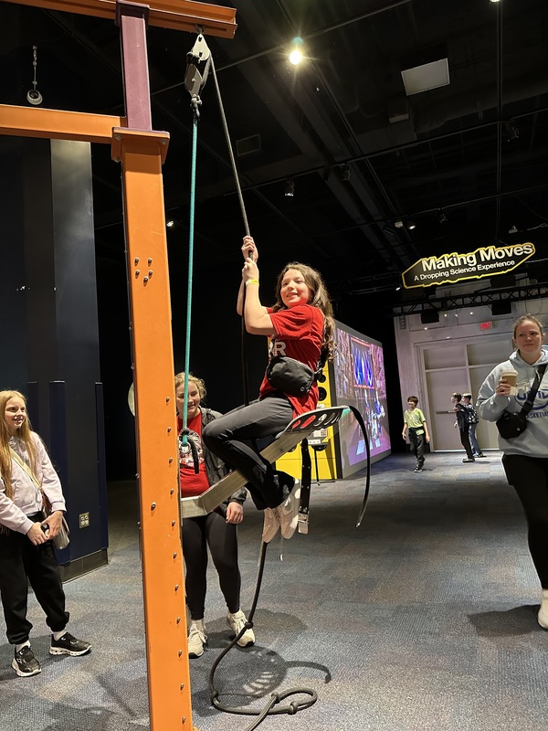 a students learning about gravity and body resistance at the science center