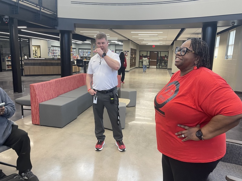 Mr. Lowery standing with hand up and Dr. Ryston with hand on her hip looking on