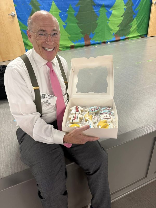 Mr. Spann with the cookies made by Ms. Putman