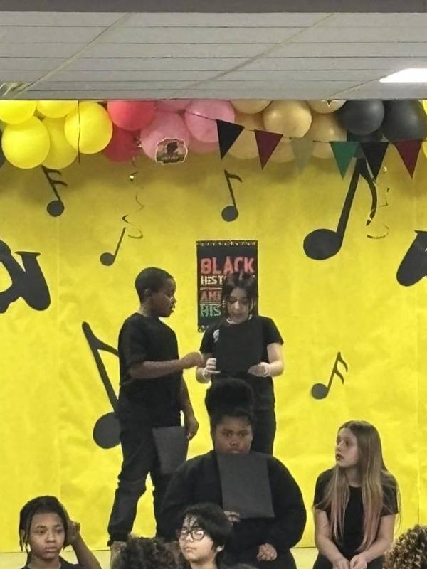 Fourth grades reading a poem written by Maya Angelou