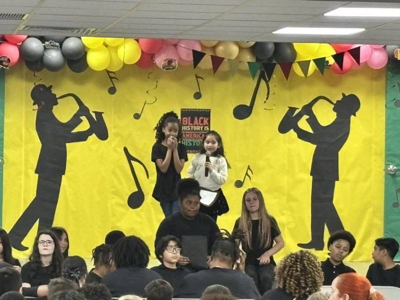 Fourth graders reading a Langston Hughes poem