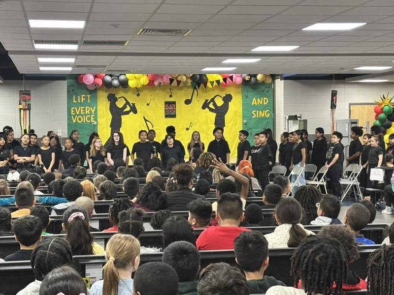 Fifth grade singing at the front of the cafeteria