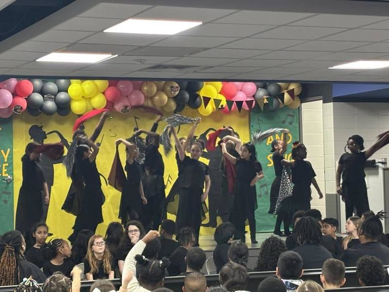 Students dancing on stage for the program