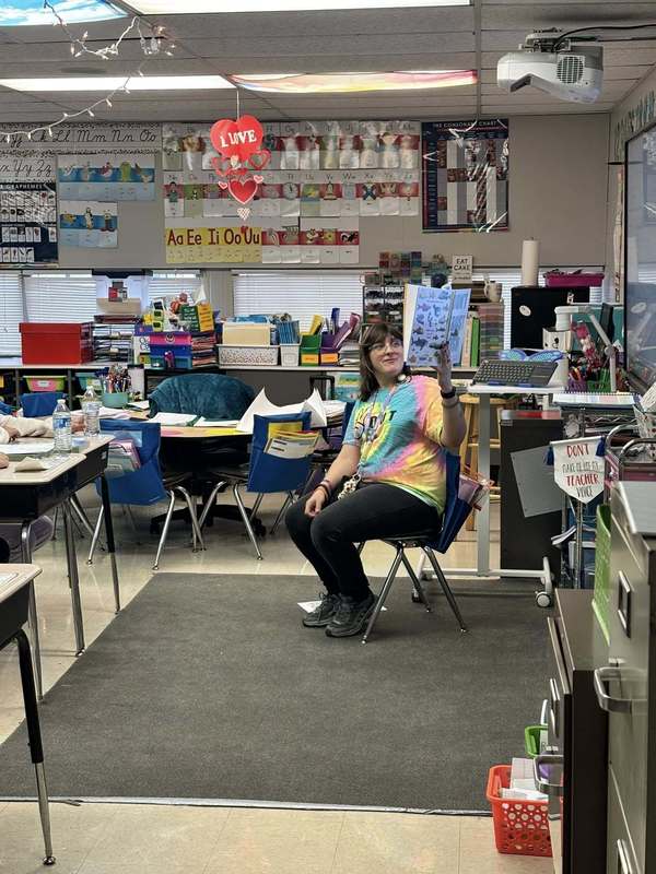 Ms. Black reading to Ms. Johnson's class