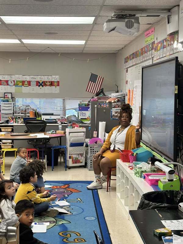Ms. Toney reading to Ms. Howard's first grade class