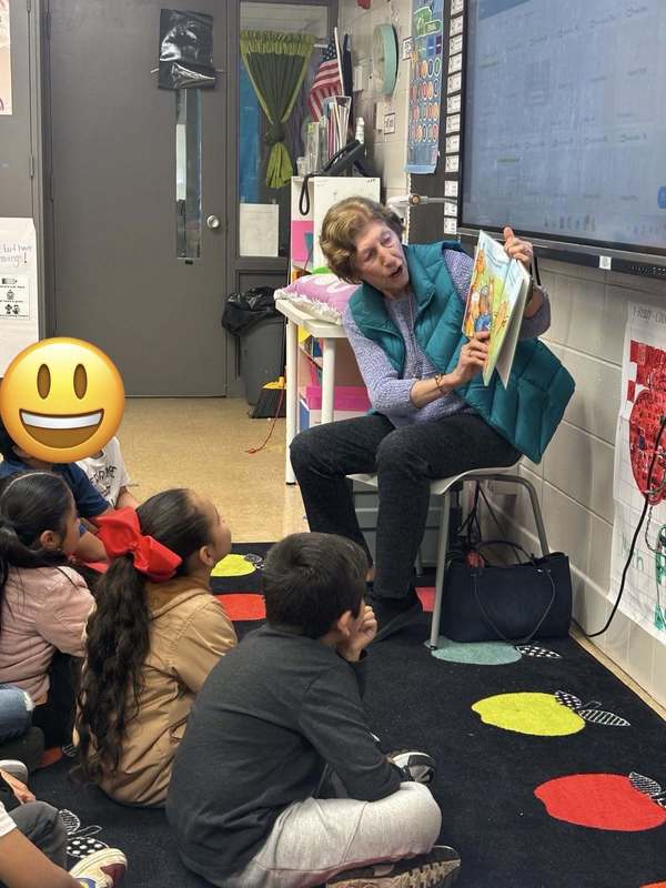 Guest reader reading to a second grade class