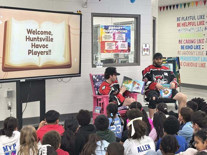 Two Huntsville Havoc players read to third grade in the library