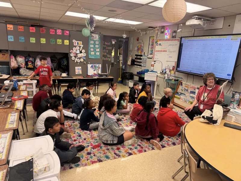 Ms. Brown, one of our reading interventionists, reading to a 2nd grade class
