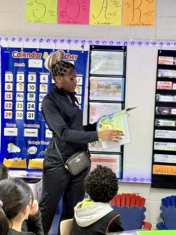 Columbia High School student reading to a class