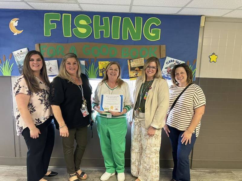 Ms. Stegen surrounded by Leadership Team and Community Volunteers as she holds her certificate