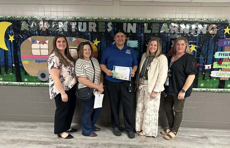 Ms. Navarro surrounded by Leadership Team and Community Volunteers as she holds her certificate