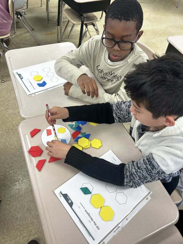 Fourth graders working with tangram puzzles.