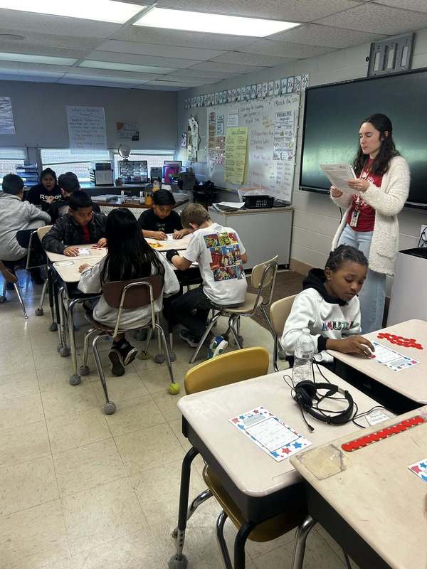 Ms, Moody directing her class in how to play ACAP Bingo