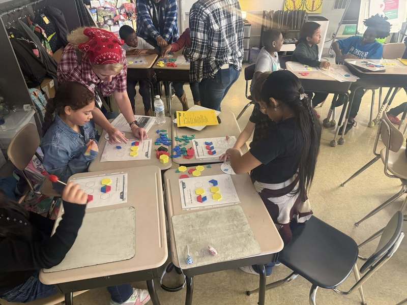 Third graders working with tangram puzzles.