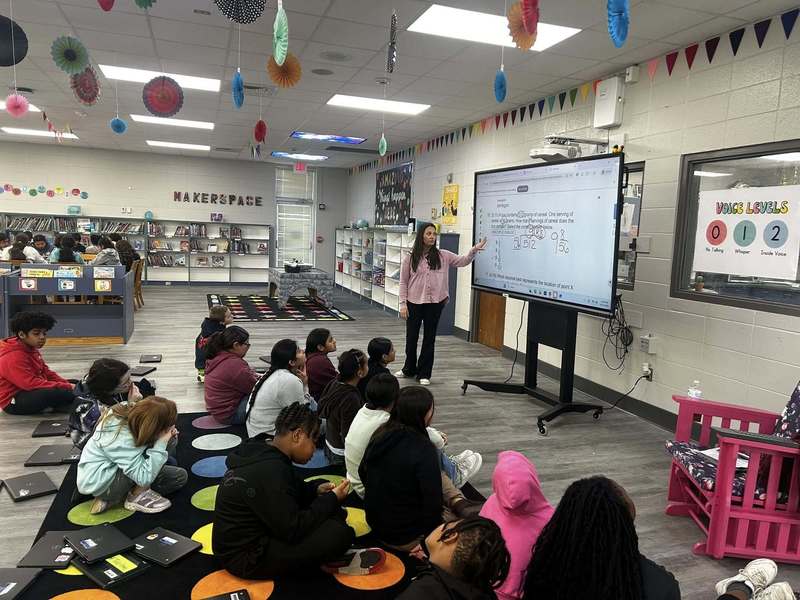 Ms. Treece going over math strategies with fifth graders.