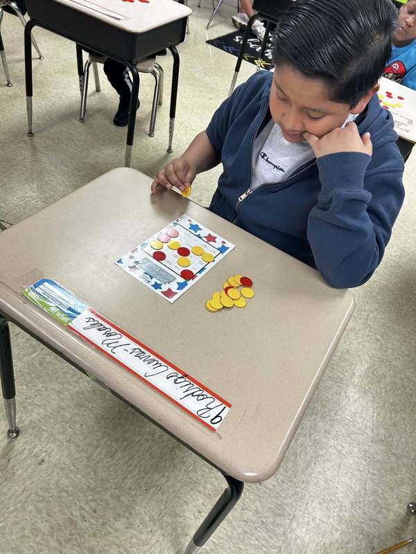A second grader playing Math ACAP Bingo.