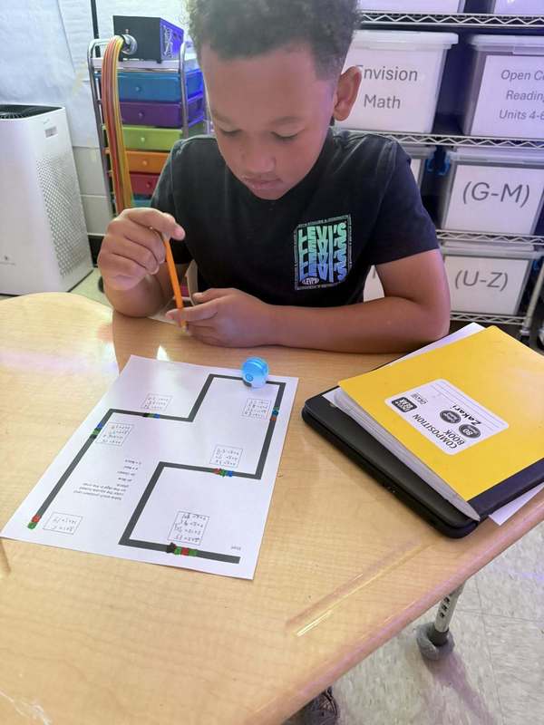 Third grader learning to use Ozobots in a math activity