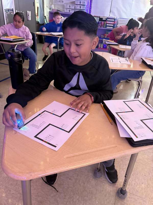 Student working on his Ozobot and math activity. 