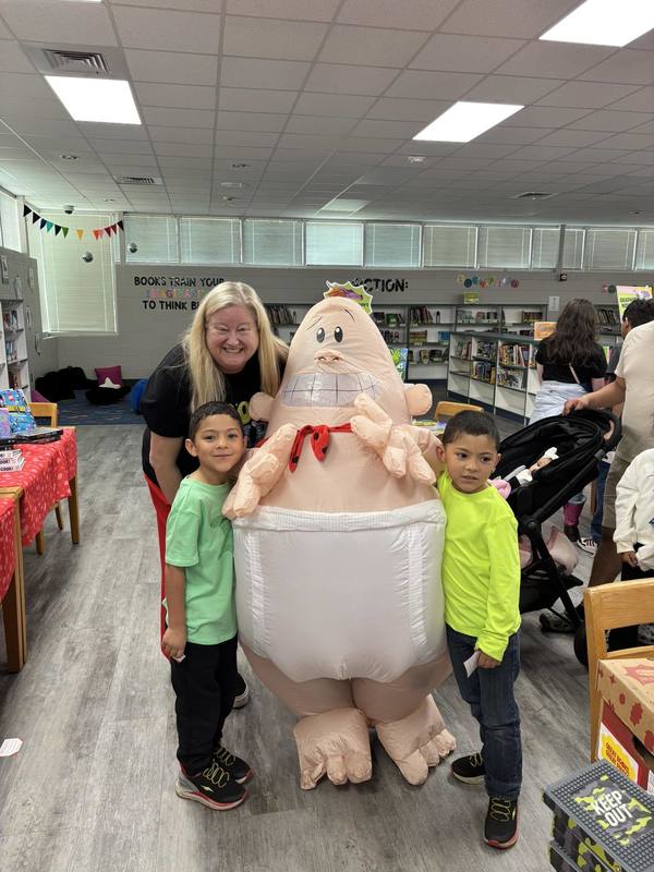 Captain Underpants visiting with Mrs. Gatzke and some students at the Book Fair.