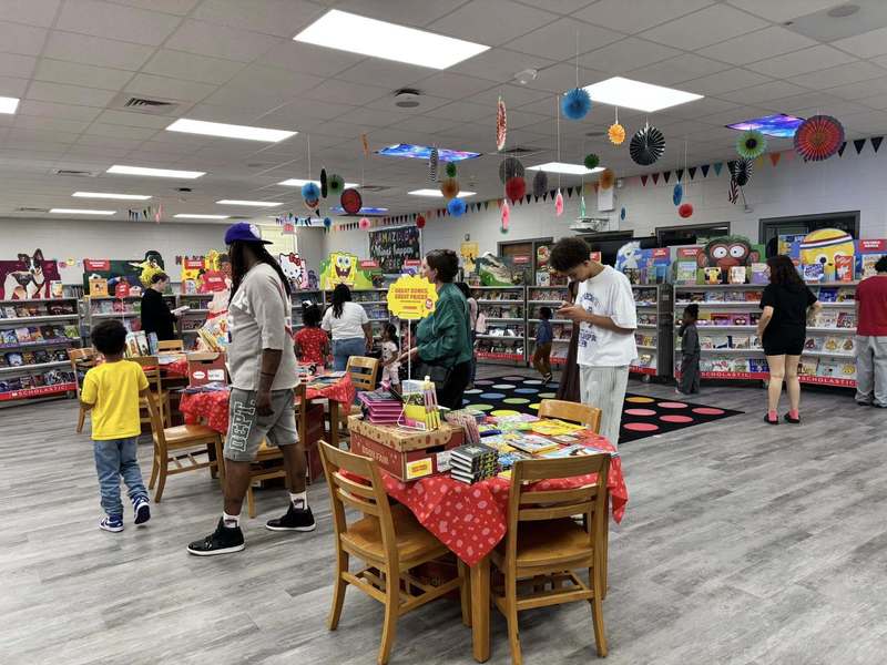 Families shopping the book fair in the library