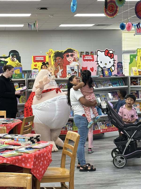 Captain Underpants giving students high fives
