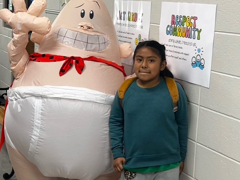 Captain Underpants visiting with a student