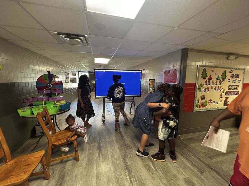 Third grade teachers helping students with a literacy activity