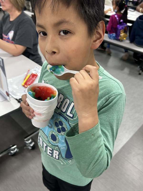 Student enjoying a shaved ice from Pinguinos Hermanos